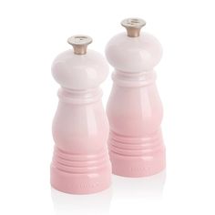 two pink salt and pepper shakers on a white background