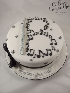 a birthday cake decorated with musical notes and music staff on it's white frosting