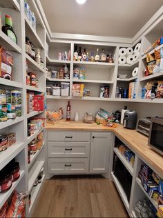 a large pantry with lots of food on the shelves and cupboards full of items