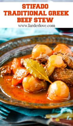 a close up of a plate of stew with potatoes and meat in tomato gravy