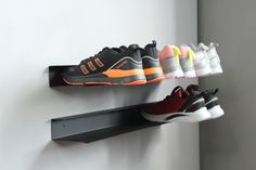 there are five pairs of shoes hanging on the wall