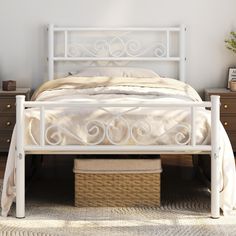 a white bed sitting next to a dresser with drawers on each side and a wicker basket under it