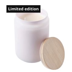 a white candle with a wooden lid and the words limited edition written in black on it