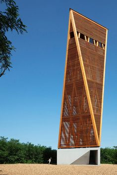 a tall wooden structure sitting in the middle of a field