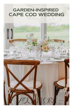 an image of a table set for a wedding with flowers and wine glasses on it