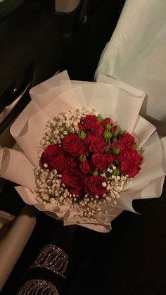 a bouquet of red roses and baby's breath