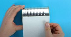 a person is holding a roll of paper with their fingers on it and pressing down the edge