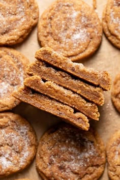 a pile of cookies with powdered sugar on top