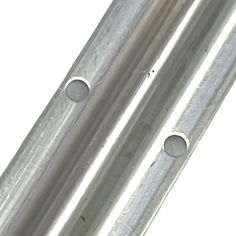 two metal tubes with holes in the middle