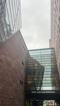 the entrance to an office building with people walking around