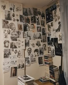 a room filled with books and pictures on the wall next to a window covered in curtains