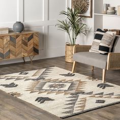 a living room with a rug, chair and potted plant