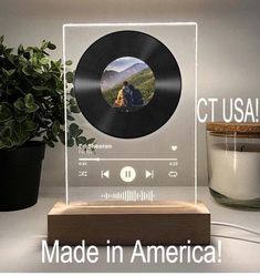 a record player is shown with the words made in america on it and next to a potted plant