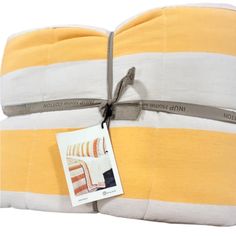 the yellow and white striped blanket has a tag on it