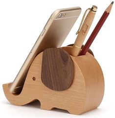 an elephant pen holder with a cell phone and pencil