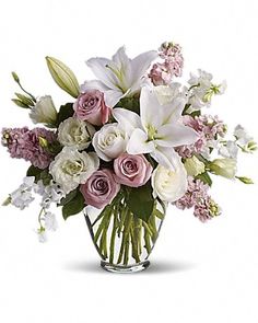 a vase filled with white and pink flowers