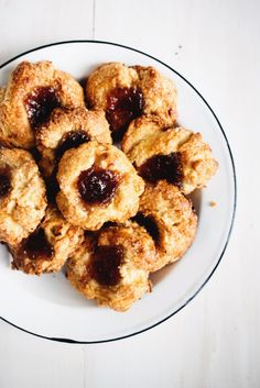 a white plate topped with cookies covered in jelly