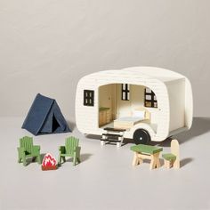 a toy camper is set up with furniture