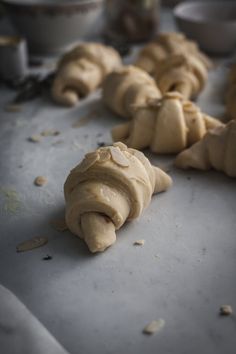 some doughnuts are laying on a table and ready to be baked in the oven