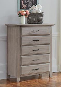 a dresser with flowers and a basket on top