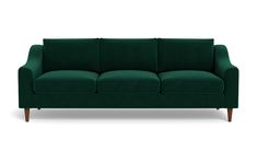 a green couch sitting on top of a white floor