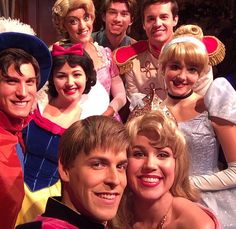 a group of people dressed in costumes posing for a photo together with one woman wearing a tiara