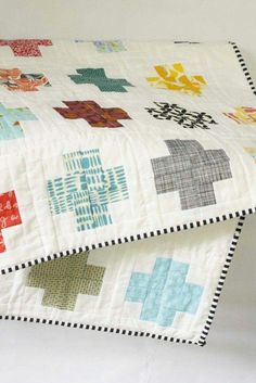 a close up of a quilt on a bed