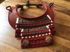 a red purse sitting on top of a wooden table