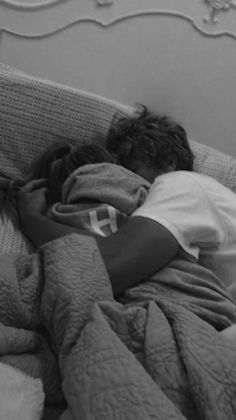 black and white photograph of a person sleeping on a bed