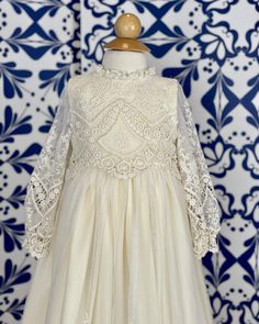 A unique and exquisite full vintage lace gown. Beautiful hand-embroidered lace in ivory. It has three clip-on on the back for closure. Does not include bonnet Made in Spain 100% polyester Dry Cleaning Final Sale, no exchanges nor returns are available Elegant Baptism Dress With Fitted Bodice And Lace, Elegant Gown With Lace Sleeves For First Communion, White Lace Dress With Lace Bodice For Ceremonies, Elegant Lace Dress For First Communion, Off White Lace Dress For Wedding, Cream Baptism Dress With Lace Bodice For Formal Occasions, Formal Cream Baptism Dress With Lace Bodice, Elegant Lace Bodice Dress For First Communion, Elegant Lace Trim Dress For Ceremony