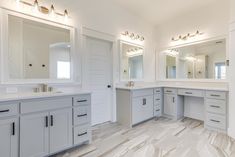 a large bathroom with two sinks and mirrors