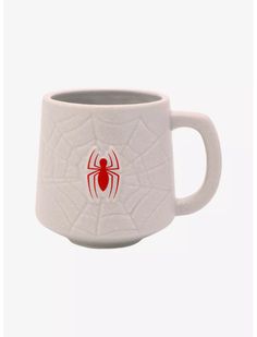 a white mug with a red spider on it