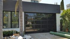 a large garage door is open in front of a house