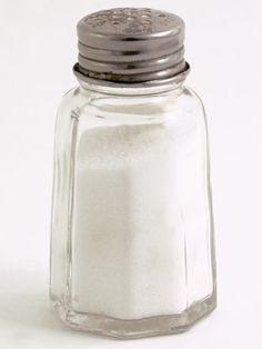 a salt shaker sitting on top of a white table