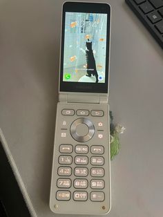 a cell phone sitting on top of a table next to a keyboard and mouse,