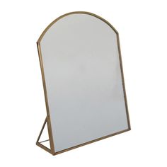 a white and gold mirror with a metal stand on it's side, against a white background