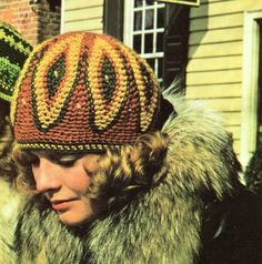 a woman wearing a knitted hat and fur coat