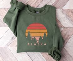 This Alaska sweatshirt is great for the Alaska lovers out there!  Also a fun shirt to wear on your upcoming Alaska cruise.  This unisex, heavy blend crewneck sweatshirt is pure comfort and will quickly become your go-to.     COLOR: This Gildan 18000 sweatshirt comes in several colors, look at the drop down for options.   SIZING: These sweatshirts are UNISEX in size.  Please check the size chart in listing photos for best fit!   MATERIAL:  -Made from polyester and cotton with a ribbed knit collar Mountain Shirt, Christian Sweatshirt, Faith Shirt, Sedona Arizona, Outdoor Gift, Gildan Sweatshirts, Cozy Sweatshirts, Look Plus, Christian Shirts