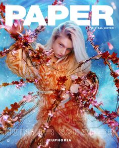 the cover of paper magazine featuring a woman with white hair and flowers in her hands