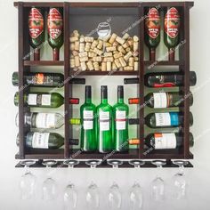 wine bottles and glasses are arranged in wooden crates