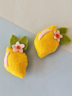 two small yellow and green objects with flowers on them