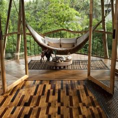 a hammock in the middle of a room with wood flooring and walls