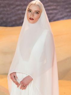 a woman wearing a white veil and dress