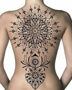 the back of a woman's body with an intricate tattoo design on her stomach