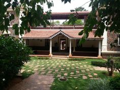 the courtyard of a house with grass and trees