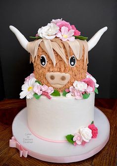 a cake decorated with flowers and a cow head