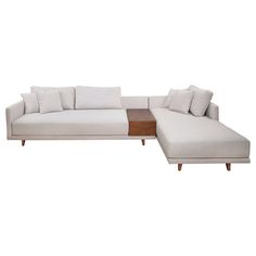 a white sectional couch with pillows on it