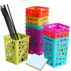 four different colored baskets with pens and notebooks in them