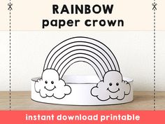 a paper crown with rainbows and clouds on it