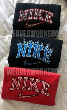 three nike headbands laying on top of a bed